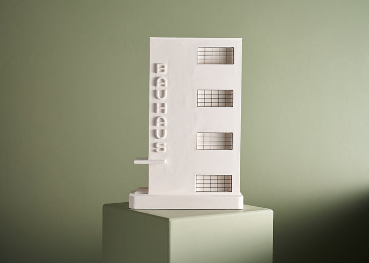 Bauhaus Dessau architectural model sitting on a green plinth against a green background