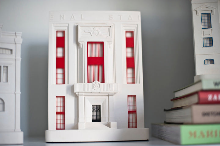 Arsenal's Highbury Stadium architectural scale facade model on a shelf with other models